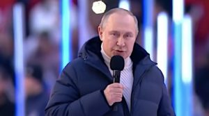 Russian President, Vladimir Putin, holds a microphone